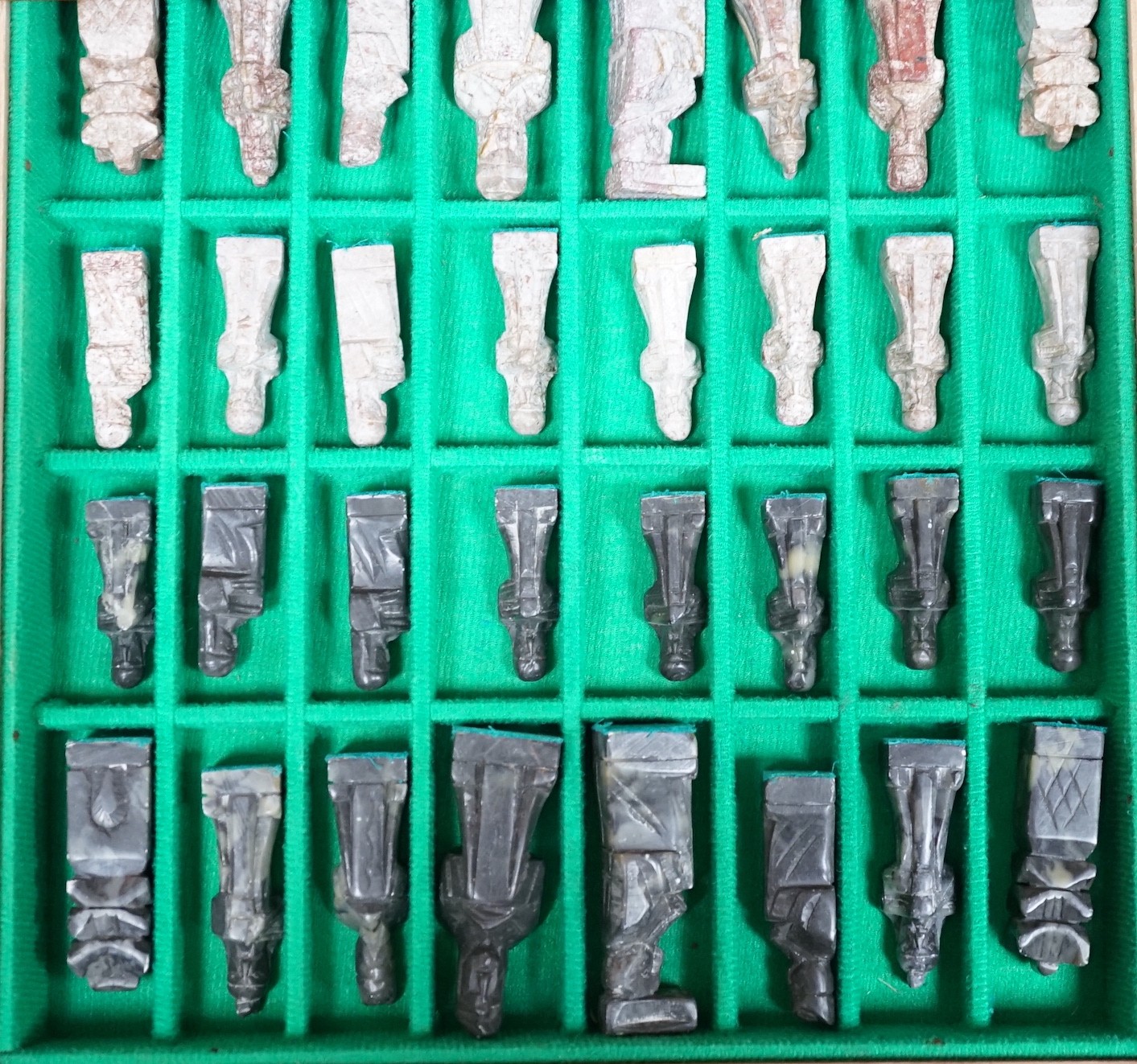 A chess board, with carved soapstone chess pieces